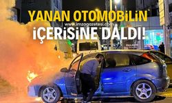 Yanan otomobilin içerisine girip telefonunu aldı!