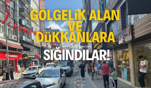 Gölgelik alan ve dükkanlara sığındılar